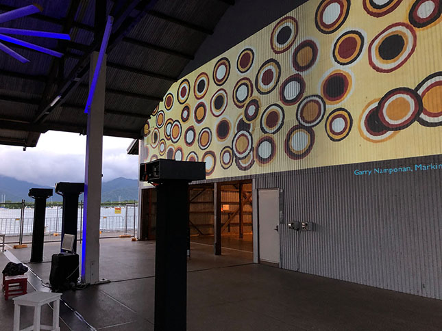 projecton of indigenous artwork on the facade of a cairns cruise liner terminal in 2019